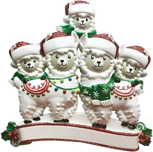 Detail of resin llama family Christmas ornament with festive red hats and DIY banner