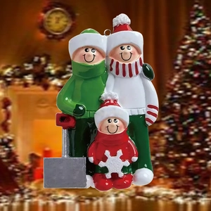 Customizable resin Christmas sled ornament featuring a family of three in winter outfits