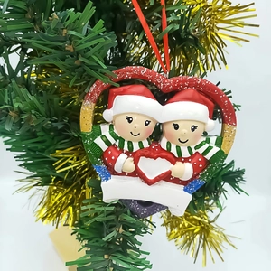 Custom snowman couple heart ornament hanging on a festive Christmas tree with glitter