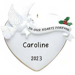 Macro detail of custom memorial heart ornament with white dove and name Caroline