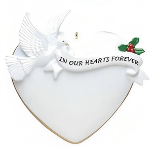 Macro detail of heart-shaped resin ornament with white dove and commemorative text