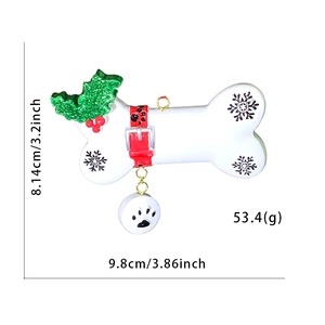 Christmas bone dog tag ornament with resin holly and paw prints on white background