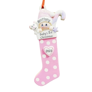 Detail of pink resin Christmas stocking ornament with baby and bear for 1st Christmas