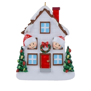 Detailed resin Christmas house ornament with snow roof and two kids in Santa hats