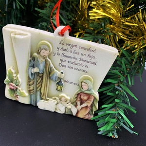Holy Family nativity resin ornament with Spanish scripture on festive Christmas tree