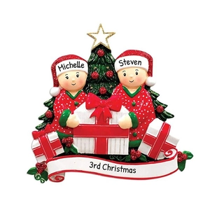Custom resin Christmas ornament featuring two figures, a festive tree, and personalized names