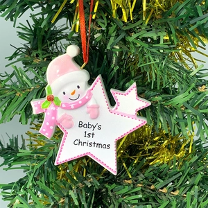 Macro shot of resin snowman ornament with Baby's 1st Christmas text on stars