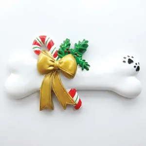 DIY Resin Christmas tree ornament shaped like a bone with gold bow and paw print decoration