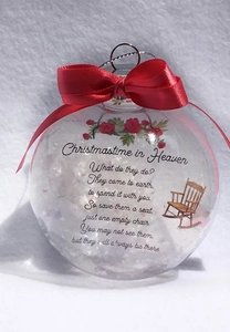 Detail of Christmas memorial bauble with red ribbon, snow fill and a rocking chair print
