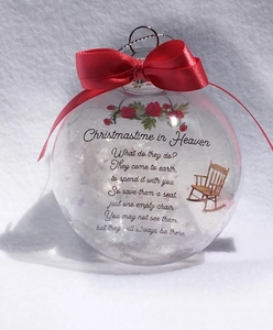 Detail of Christmas memorial ornament featuring a wooden chair illustration and a red bow