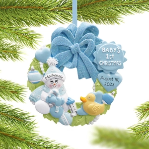 Detail of blue snowman resin ornament with Mackenzie engraving on a Christmas tree