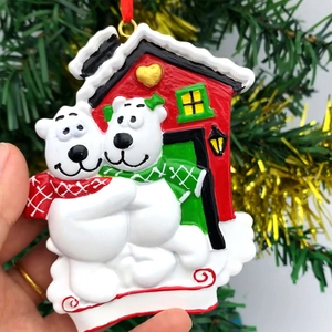 Christmas polar bear house resin hanging ornament with festive red ribbons and snow