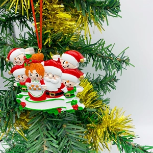 Detail of DIY Christmas resin ornament with Santa characters hanging on a tree