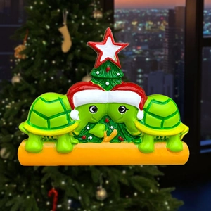 Detailed resin Christmas ornament featuring two green turtles with a mini festive tree