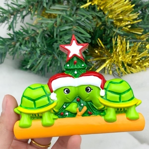 Macro detail of hand-painted resin sea turtle Christmas ornament with red festive hats