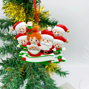 Macro detail of DIY resin Christmas ornament featuring Santa and elves hanging on a tree
