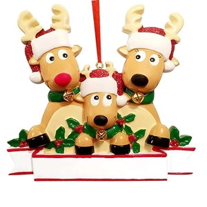 Macro detail of DIY resin Christmas reindeer family ornament with white banner for names