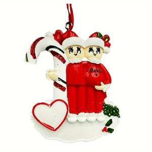 Detail of candy cane ornament with expectant parents figurines and customizable heart