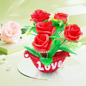 Macro shot of artificial red roses in a red LOVE pot for Valentine's home decoration