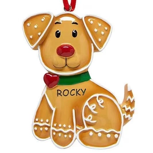 Detail of custom resin yellow dog Christmas ornament with red ribbon and Rocky nameplate