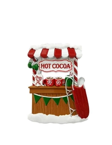 Close-up of resin Hot Cocoa stand ornament with red stripes and snowy sled detail
