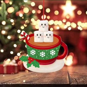 Red Christmas mug ornament with marshmallow characters and candy cane on holiday background