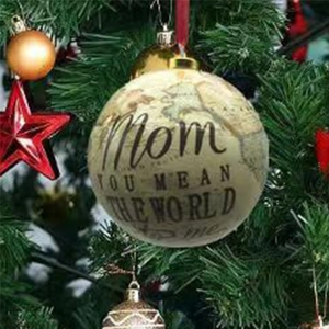 Detail of Mom Christmas ornament with vintage map texture hanging on a tree branch