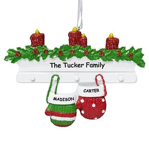 Close-up of personalized resin Christmas fireplace ornament with candles and name detail