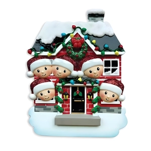 Macro detail of a resin Christmas house ornament with snow textures and 5 cute figures