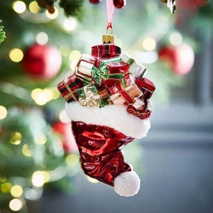Resin Christmas stocking ornament filled with gift boxes on a decorated holiday tree