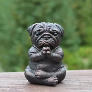 Meditating pug dog garden statue made of resin with a dark bronze finish for outdoor decor