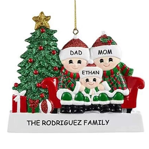 Custom resin Christmas tree ornament with a family of three sitting on a red sofa
