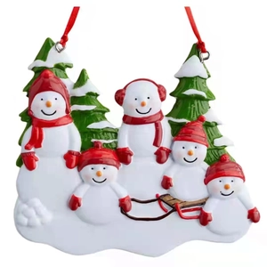 Christmas tree hanging ornament featuring resin snowman family of five with snowy pine trees