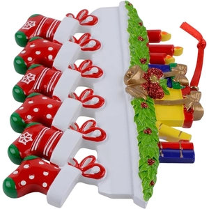 Close-up of resin Christmas stockings hanging ornament with red bows and gold bells
