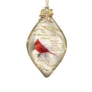 Marquise shaped Christmas cardinal ornament with gold bow and memorial text on white background
