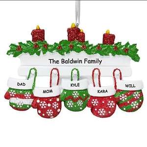 Macro detail of resin Christmas ornament with 5 gloves and candles for family names
