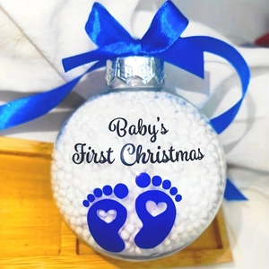 Baby's First Christmas clear ornament with blue footprints and white foam filling