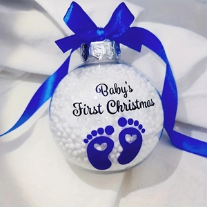 Detail of transparent Baby's First Christmas ornament with blue footprints and ribbon