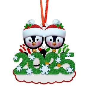 Detail of 2025 Penguin Family ornament with red hats, green glitter, and DIY name space