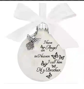 Detail of memorial angel feather ball ornament with white ribbon and silver wing charm