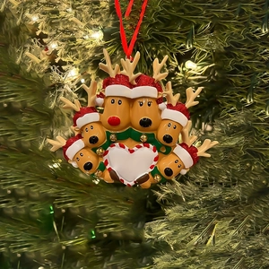 Detailed view of resin reindeer family ornament hanging on a Christmas tree branch