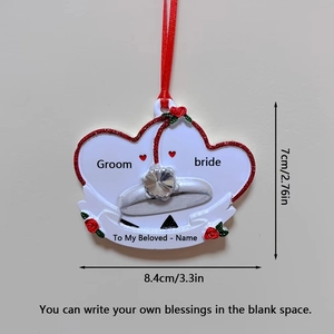 Close-up of personalized resin wedding heart ornament with Groom and Bride text