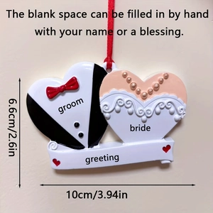 Detailed view of resin wedding couple heart ornament with tuxedo and bridal gown motifs
