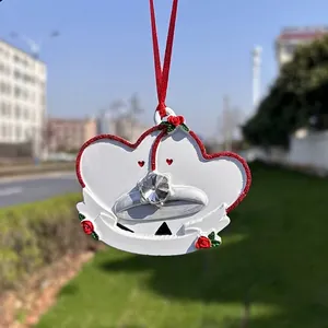 Romantic double heart ornament with red roses and wedding ring detail in natural light