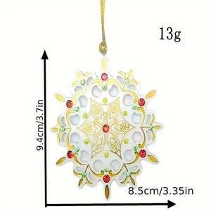 Detailed view of white snowflake ornament with gold patterns and dimensions 9.4cm x 8.5cm