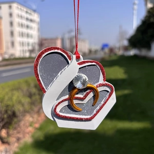 Flat heart-shaped Christmas tree ornament featuring a romantic ring and jewelry box design