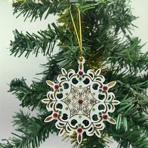 Acrylic Christmas snowflake ornament with gold patterns and colorful rhinestones on tree