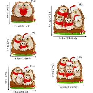 Detail of hand-painted resin hedgehog family ornaments with festive Christmas decorations