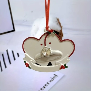 Detail of double heart resin Christmas ornament with rose relief and ribbon