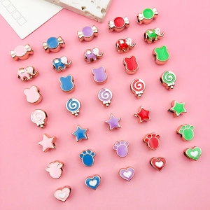 Macro view of assorted colorful enamel animal and star charms for DIY jewelry making